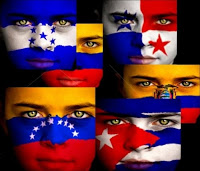 Various faces with Latin American flags painted on them